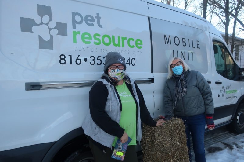 pet outreach staff delivering straw for dog houses