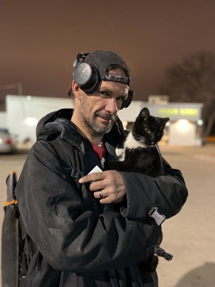 houseless man hugging cat