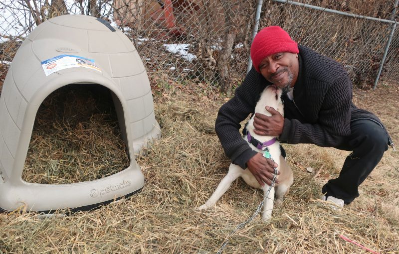 Darrell and his dog Sandy posing next to her new dog house