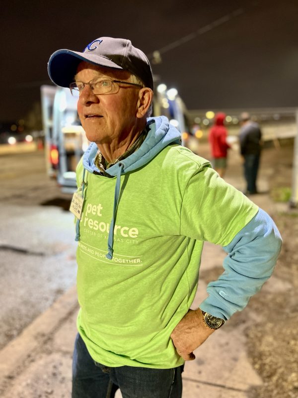 A veterinarian waits for pets at a stop. 