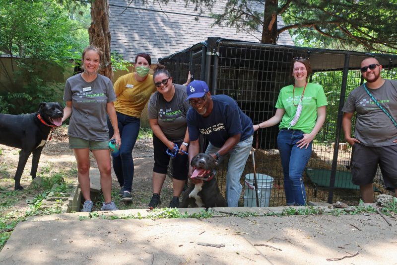 Members of our team posing with Robin and his two dogs for a group photo