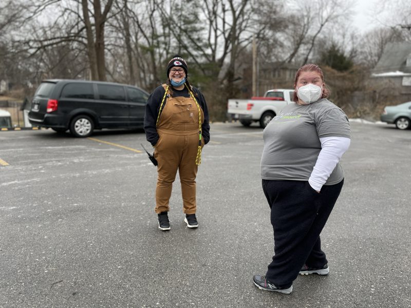 volunteer and staff member hosting drive-thru vaccination clinic