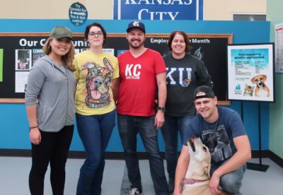 a group of volunteers stand together for a photo