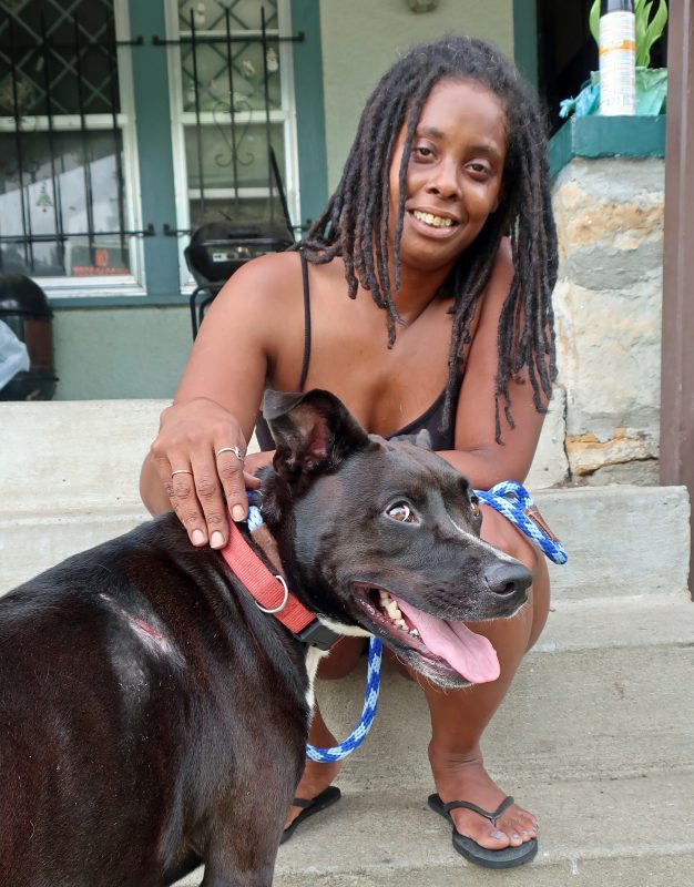 Woman and dog both smiling at the camera