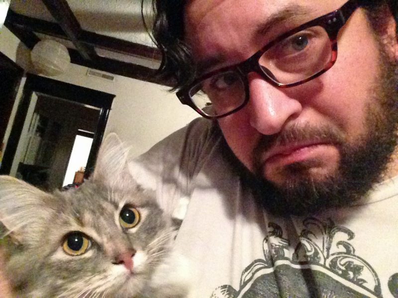 man takes selfie with cat