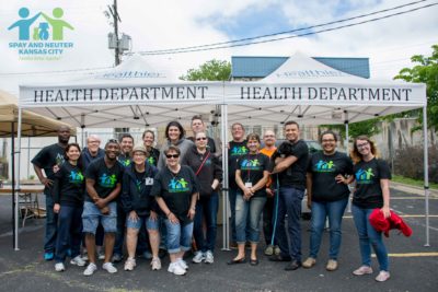 a group of volunteers stand together for a group photo