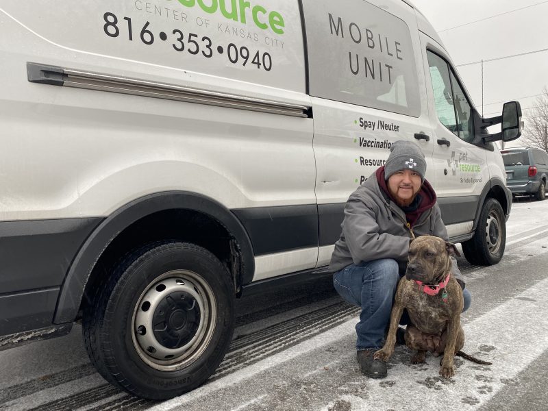 outreach team member with dog in snow