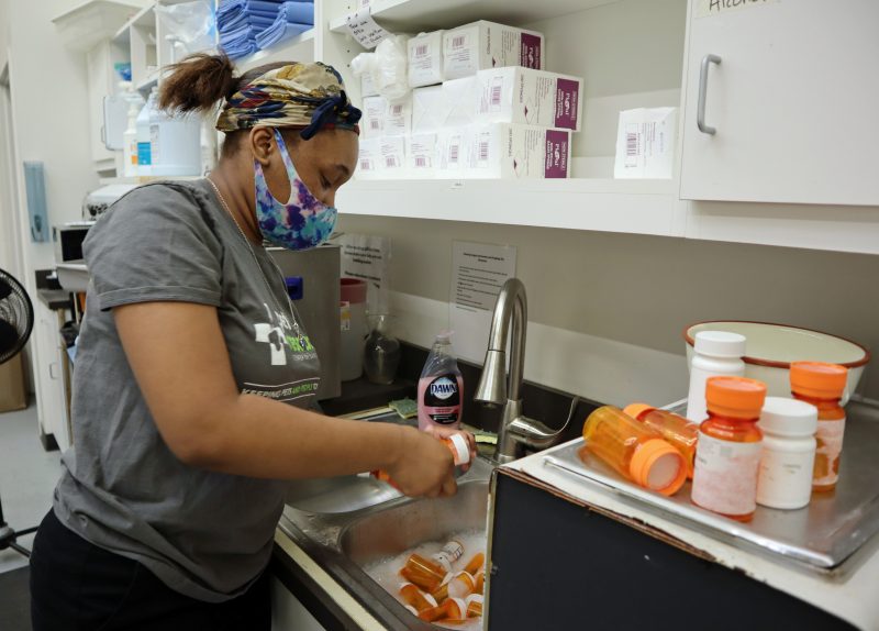 high school intern cleaning pill bottles