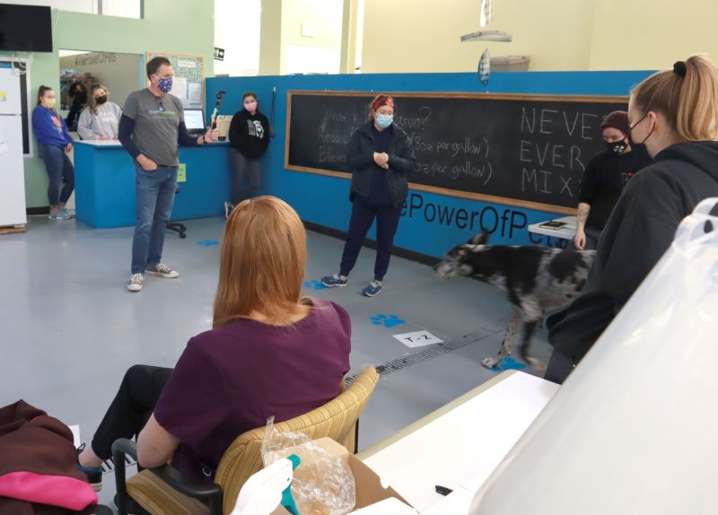 a group of people stand in a large room talking