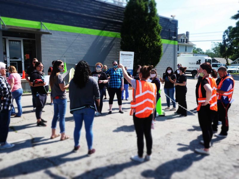 a group of people stand in a circle, discussing