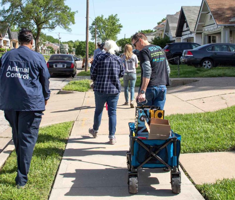 A man pulls a wagon loaded with supplies.