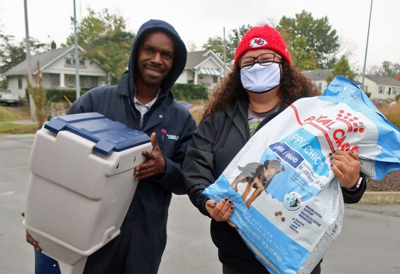 man receive pet food and storage container from PRCKC